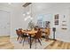 Dining room with modern light fixture, table, chairs, and sleek decor at 6509 Archwood Ave, Raleigh, NC 27616