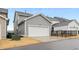 This image shows the 2-car garage with an automatic door, as well as solar panels on the roof at 6509 Archwood Ave, Raleigh, NC 27616