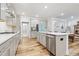 Modern kitchen with gray cabinets, stainless steel appliances, and a kitchen island at 6509 Archwood Ave, Raleigh, NC 27616