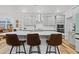 Modern kitchen island with barstool seating and stainless steel appliances at 6509 Archwood Ave, Raleigh, NC 27616