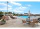 This image shows the community pool with lounge chairs, tables and umbrellas at 6509 Archwood Ave, Raleigh, NC 27616
