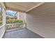 Back deck with wooden flooring, gray railings and ceiling, next to a home at 6509 Sunset Manor Dr, Wake Forest, NC 27587