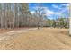 Picture of a backyard with a dirt path, trees, and dried grass at 6509 Sunset Manor Dr, Wake Forest, NC 27587