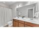 Bathroom featuring double sinks, wood cabinets, and a shower curtain for added convenience at 6509 Sunset Manor Dr, Wake Forest, NC 27587