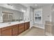 Bathroom featuring double sinks, tile floors, a large mirror, and a separate shower at 6509 Sunset Manor Dr, Wake Forest, NC 27587