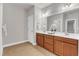 Double vanity in bathroom with matching cabinets, white countertops, and large mirror at 6509 Sunset Manor Dr, Wake Forest, NC 27587
