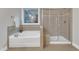 Bathroom features a soaking tub with tiled surround and glass-enclosed shower at 6509 Sunset Manor Dr, Wake Forest, NC 27587