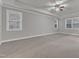 Bedroom featuring tray ceilings, carpet, and large windows at 6509 Sunset Manor Dr, Wake Forest, NC 27587