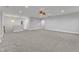 Large room with carpet floors and a hanging light fixture perfect for entertaining at 6509 Sunset Manor Dr, Wake Forest, NC 27587