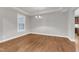 Bright dining area with a modern chandelier, hardwood floors, and a large window offering natural light at 6509 Sunset Manor Dr, Wake Forest, NC 27587