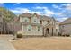 Two-story home featuring stone accents, shuttered windows, and professional landscaping at 6509 Sunset Manor Dr, Wake Forest, NC 27587