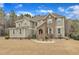 Charming two-story home with stone accents, shuttered windows, and a well-manicured front yard at 6509 Sunset Manor Dr, Wake Forest, NC 27587