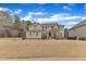 Exterior view of a two story home featuring stone accents and a spacious front lawn with mature trees at 6509 Sunset Manor Dr, Wake Forest, NC 27587