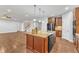 Kitchen island with stainless steel appliances, and hardwood floors in an open-concept layout at 6509 Sunset Manor Dr, Wake Forest, NC 27587