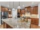 Kitchen island features a granite countertop, pendant lighting, and stainless steel appliances at 6509 Sunset Manor Dr, Wake Forest, NC 27587