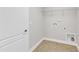 Bright laundry room with tile floors, hookups and wire shelving at 6509 Sunset Manor Dr, Wake Forest, NC 27587