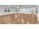 Expansive living room with hardwood floors, neutral paint, and large windows creating a bright, inviting space at 6509 Sunset Manor Dr, Wake Forest, NC 27587