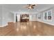 Spacious living area featuring hardwood floors, natural light, and open layout to the kitchen at 6509 Sunset Manor Dr, Wake Forest, NC 27587