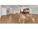 Open-concept living area showcases hardwood floors and a modern kitchen with stainless appliances at 6509 Sunset Manor Dr, Wake Forest, NC 27587