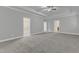 Spacious primary bedroom featuring carpet and tray ceilings at 6509 Sunset Manor Dr, Wake Forest, NC 27587