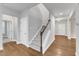Carpeted staircase featuring hardwood floors and white risers at 6509 Sunset Manor Dr, Wake Forest, NC 27587