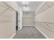 Spacious walk-in closet features carpeted floors and built-in shelving units for storage at 6509 Sunset Manor Dr, Wake Forest, NC 27587