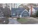 Well-maintained home exterior with gray siding, white trim, a gray roof, and a red front door at 6617 Tealbriar Dr, Raleigh, NC 27615