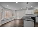 Bright kitchen featuring granite countertops, modern lighting, and hardwood floors at 6817 Ramblewood Dr, Hillsborough, NC 27278