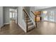 Inviting foyer with a carpeted staircase and views into the living spaces at 8304 Bellingham Cir, Raleigh, NC 27615