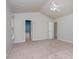 Bright bedroom with neutral walls, vaulted ceiling, and carpet flooring at 8409 Astwell Ct, Raleigh, NC 27615