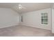 Bright and airy bedroom with neutral carpeting, a ceiling fan, and lots of natural light at 8409 Astwell Ct, Raleigh, NC 27615