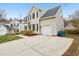 A charming home featuring an attached garage, a well-maintained driveway, and pleasing exterior at 8409 Astwell Ct, Raleigh, NC 27615