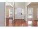 Bright foyer featuring gleaming hardwood floors, neutral walls, and a welcoming front door at 8409 Astwell Ct, Raleigh, NC 27615