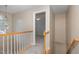 Upstairs hallway with views into a bedroom and stairway with decorative railings at 8409 Astwell Ct, Raleigh, NC 27615