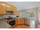 Updated kitchen with stainless steel appliances, solid countertops, and a view to the backyard deck at 8409 Astwell Ct, Raleigh, NC 27615