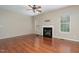 Spacious living room featuring hardwood floors, a fireplace, and bright windows for natural light at 8409 Astwell Ct, Raleigh, NC 27615
