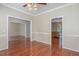 Open-concept living room with gleaming hardwood floors and a view into the kitchen at 8409 Astwell Ct, Raleigh, NC 27615