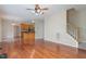 An open-concept space with hardwood floors, staircase, and kitchen with stainless steel appliances at 8409 Astwell Ct, Raleigh, NC 27615