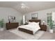 This spacious main bedroom features a ceiling fan, neutral decor, and plenty of natural light at 8409 Astwell Ct, Raleigh, NC 27615