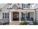 Inviting covered front porch with comfortable seating offers a relaxing outdoor space and classic charm at 8528 Mangum Hollow Dr, Wake Forest, NC 27587