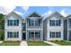 Charming two-story homes featuring vinyl siding, bright windows and professionally landscaped front yard at 8643 Brixton Shay Dr, Raleigh, NC 27616