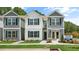 Charming townhomes featuring neutral exteriors, blue shutters, and well-manicured landscaping at 8643 Brixton Shay Dr, Raleigh, NC 27616