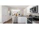 Stylish kitchen featuring stainless steel appliances, white cabinets, and granite counters with a breakfast bar at 8643 Brixton Shay Dr, Raleigh, NC 27616