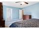 Comfortable bedroom with wood furnishings, a ceiling fan and blue painted walls at 905 Balmoral Dr, Cary, NC 27511