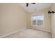 Carpeted bedroom showcasing a window, a ceiling fan, and neutral color scheme at 9221 Calabria Dr # 116, Raleigh, NC 27617