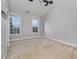 Empty bedroom featuring carpet, a ceiling fan, and two large windows at 9221 Calabria Dr # 116, Raleigh, NC 27617