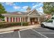 Exterior view of the community clubhouse featuring red shutters and well-maintained landscaping at 9221 Calabria Dr # 116, Raleigh, NC 27617