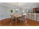 Dining area featuring hardwood floors, modern chandelier, and bar seating nearby the kitchen at 9221 Calabria Dr # 116, Raleigh, NC 27617