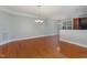 Dining area featuring hardwood floors, modern chandelier, and bar seating nearby the kitchen at 9221 Calabria Dr # 116, Raleigh, NC 27617