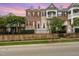 Beautiful townhome featuring brick facade, shutters, and white accents, plus manicured landscaping at 9221 Calabria Dr # 116, Raleigh, NC 27617